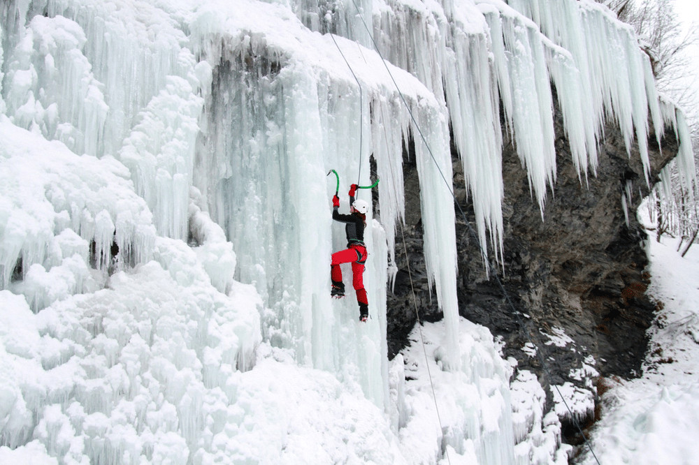 Climbers navigating a challenging ice wall