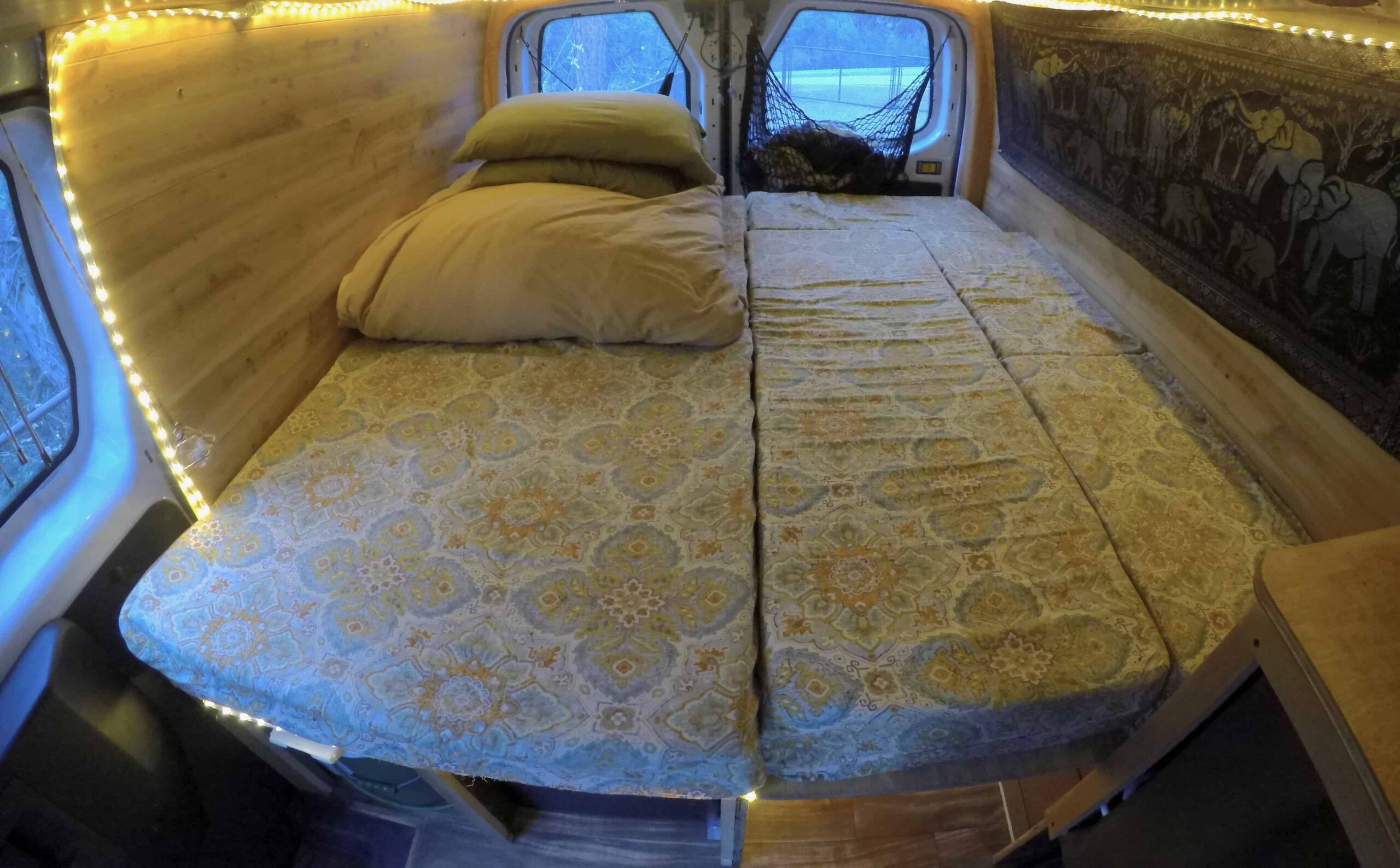 Van bed setup using a memory foam mattress cut into five cushions