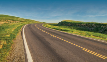 Rolling hills of the Flint Hills National Scenic Byway at sunset, showcasing the vast tallgrass prairie