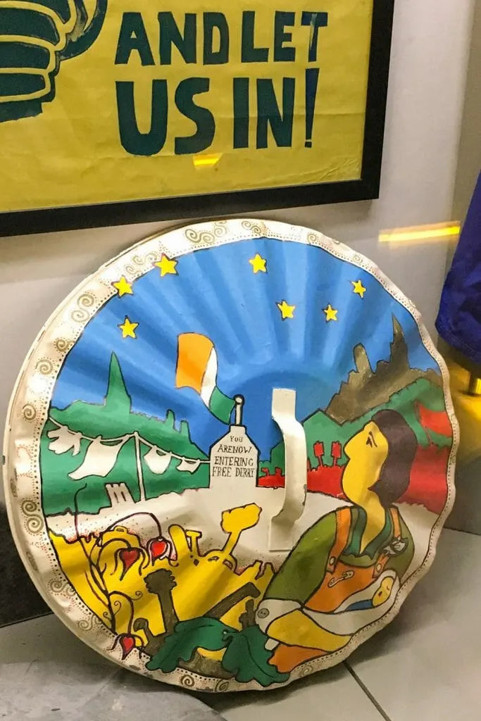 Discover Derry's recent history at the Free Derry Museum, featuring poignant displays like this painted bin lid.