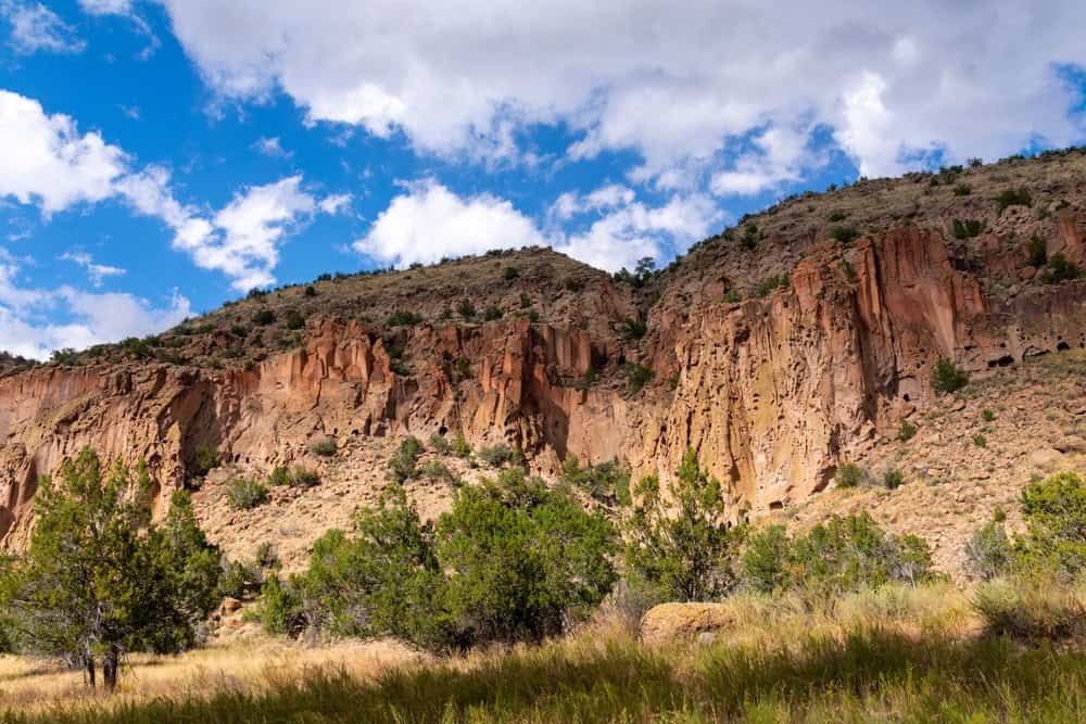 Frijoles Canyon - A beautiful view of a canyon, trees, and the sky at Frijoles Canyon