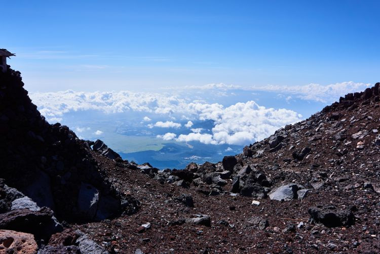 Hiker ascending the rocky trail on Mount Fuji
