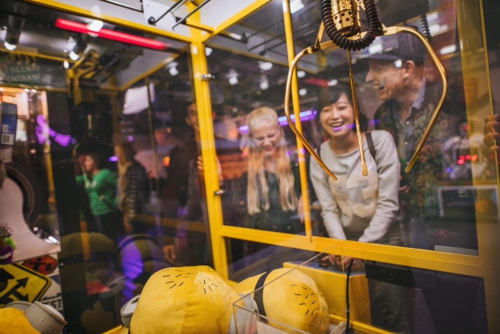 Woman playing toy grabbing game with friends