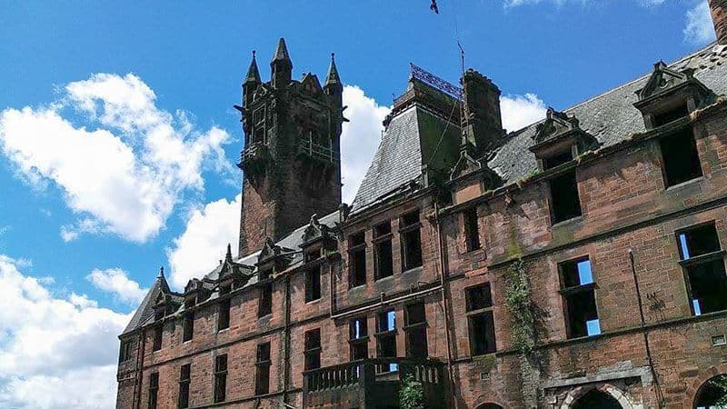 Gartloch Hospital Administration Block in Glasgow, Scotland. A remnant of the abandoned asylum, now converted into luxury housing, under a cloudy sky.