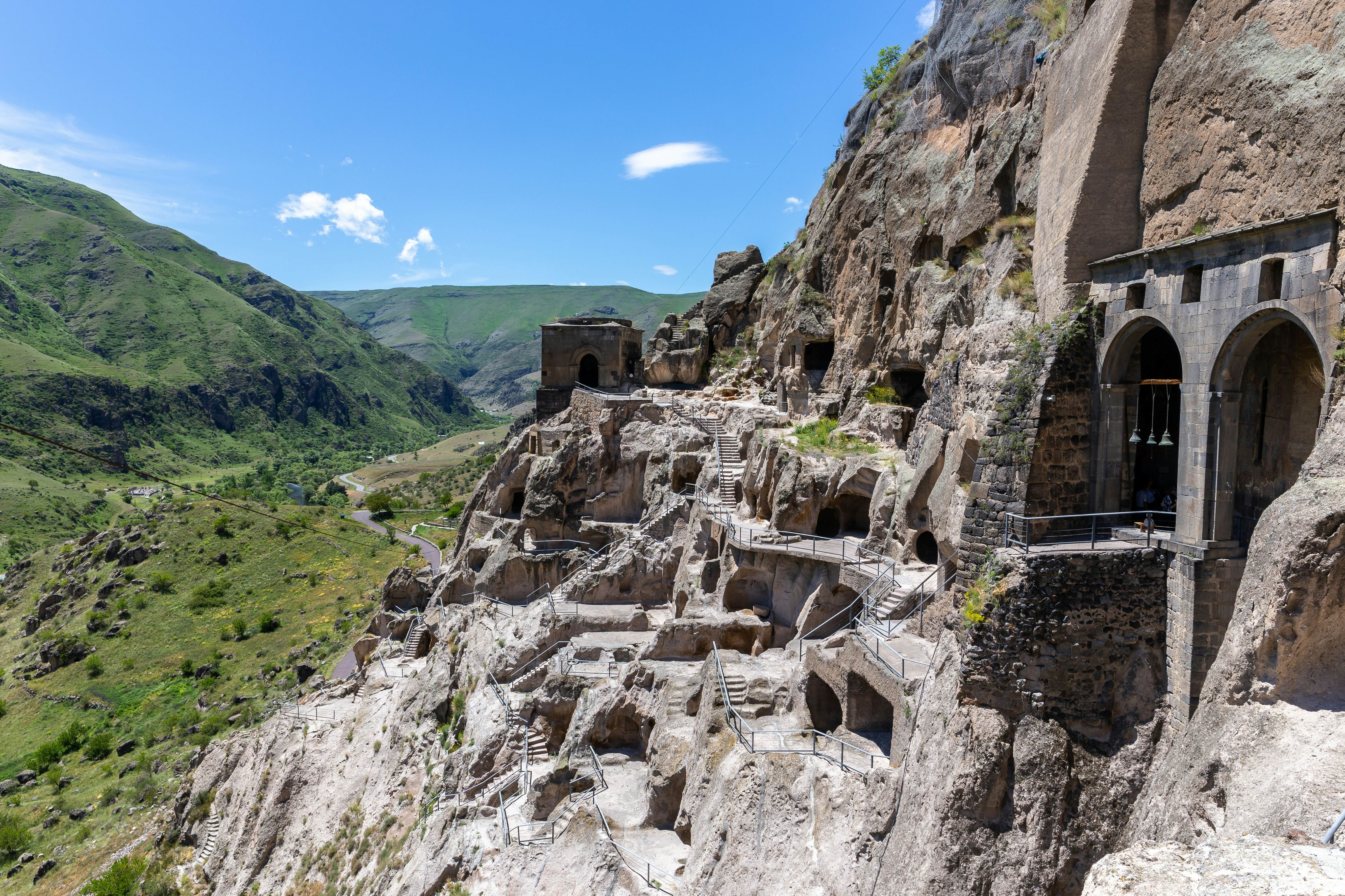A mountain escarpment with caves, tunnels and dwellings carved into the rock. There
