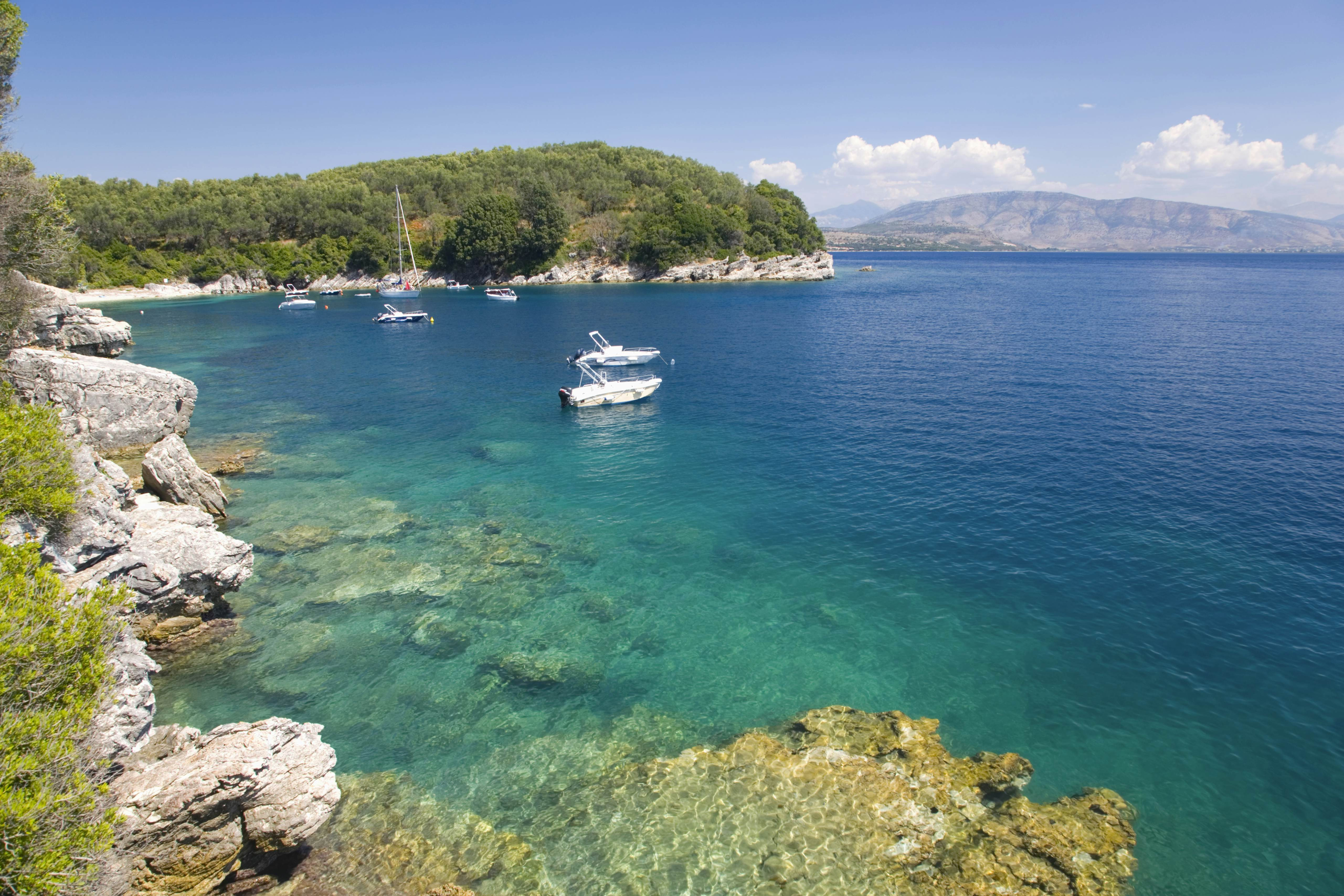 Small boats floating in a bay with turquoise water.