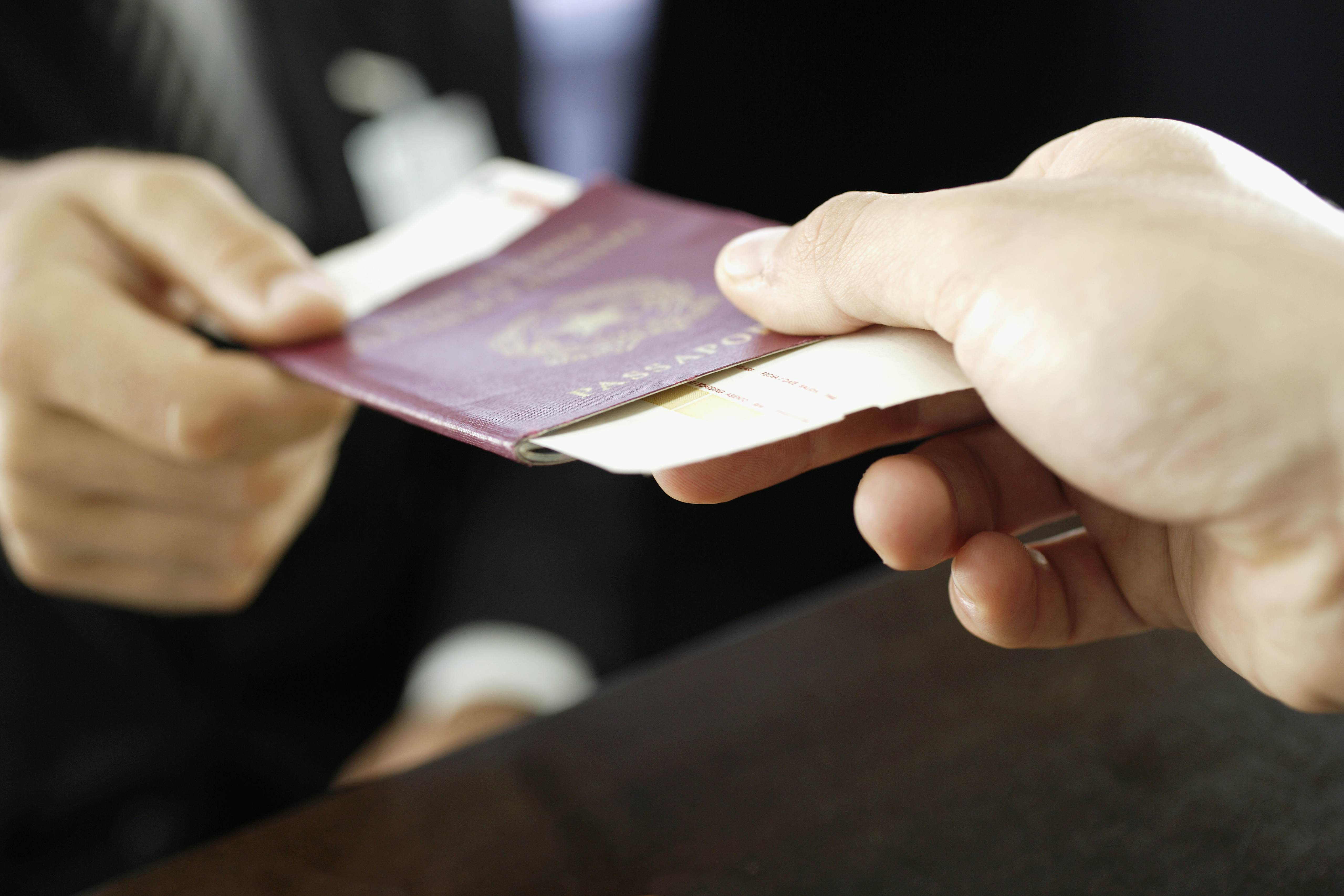 Handing over a passport with a red cover