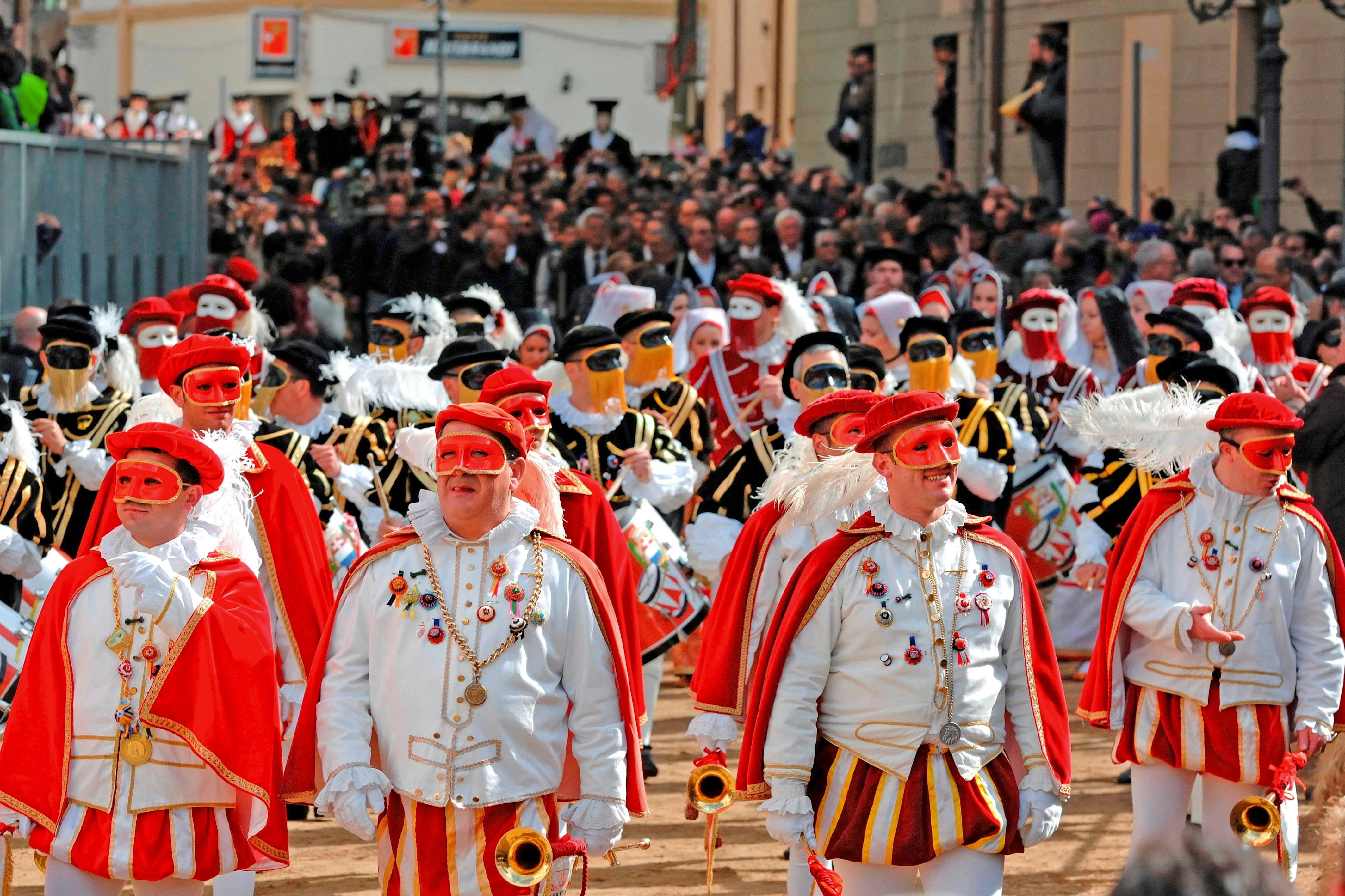 Marchers in masks and costumes on parade at the Sa Sartiglia festival, Oristano, Sardinia, Italy