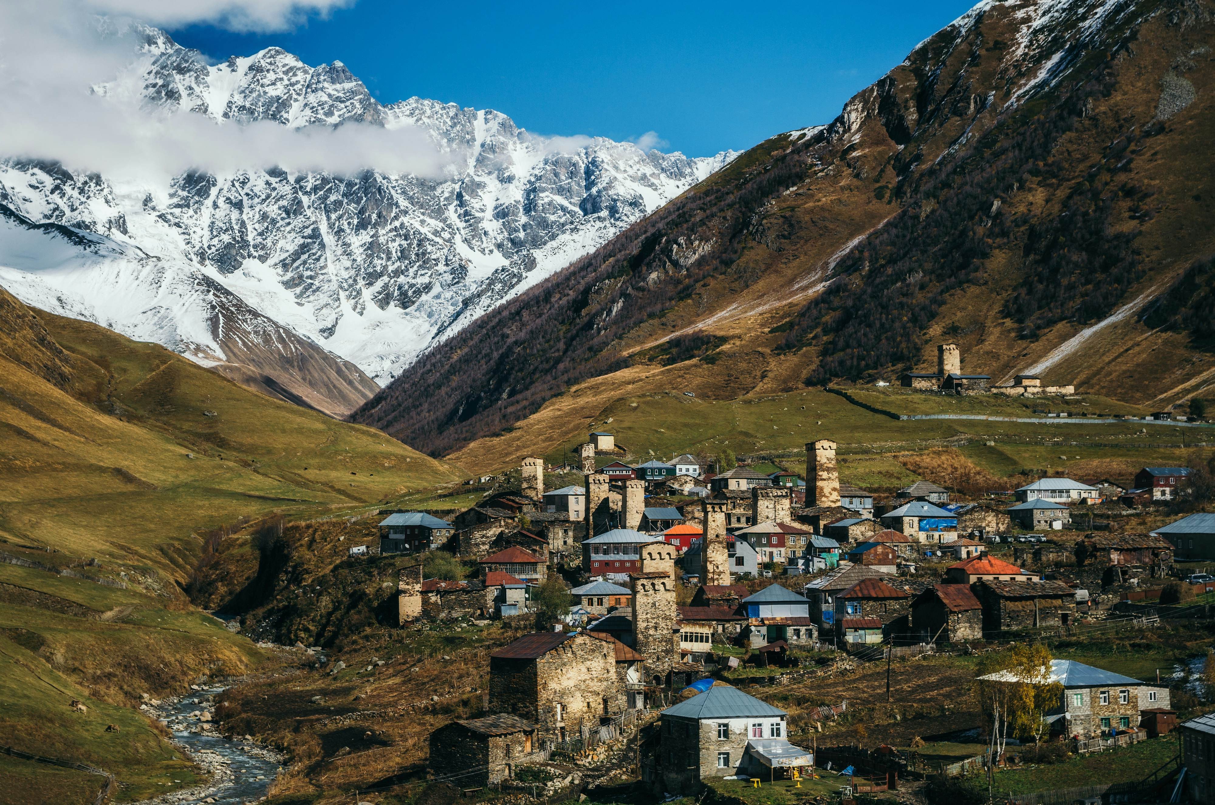A remote mountain village is surrounded by steep hills and mountains, and there