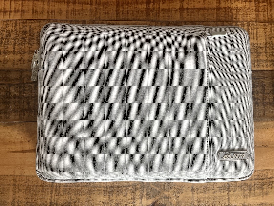 A grey MOSISO Laptop Sleeve Bag on a wooden table