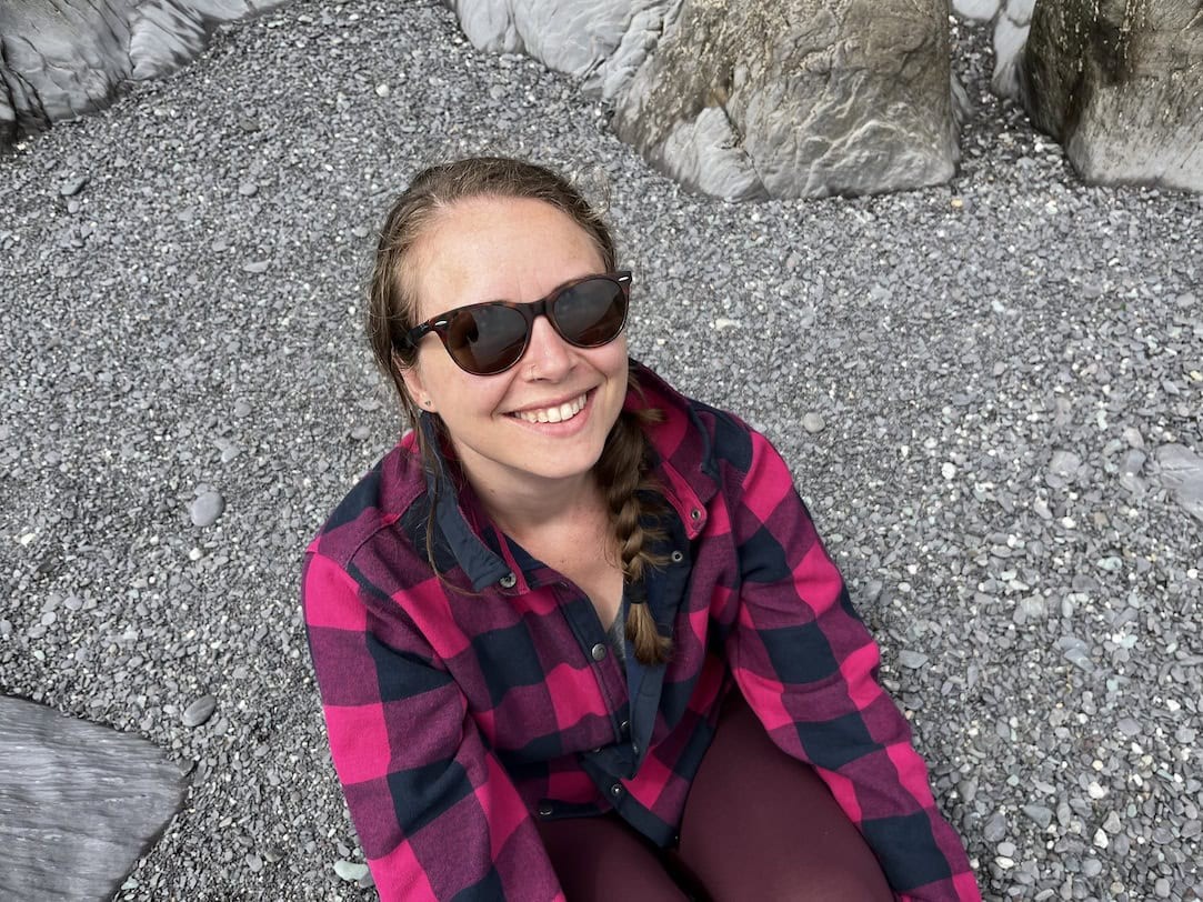 A photo of me on a sandy beach smiling at the camera