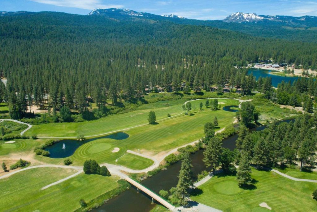 An aerial perspective of Graeagle Meadows golf course, showcasing the lush green fairways and the surrounding natural landscape