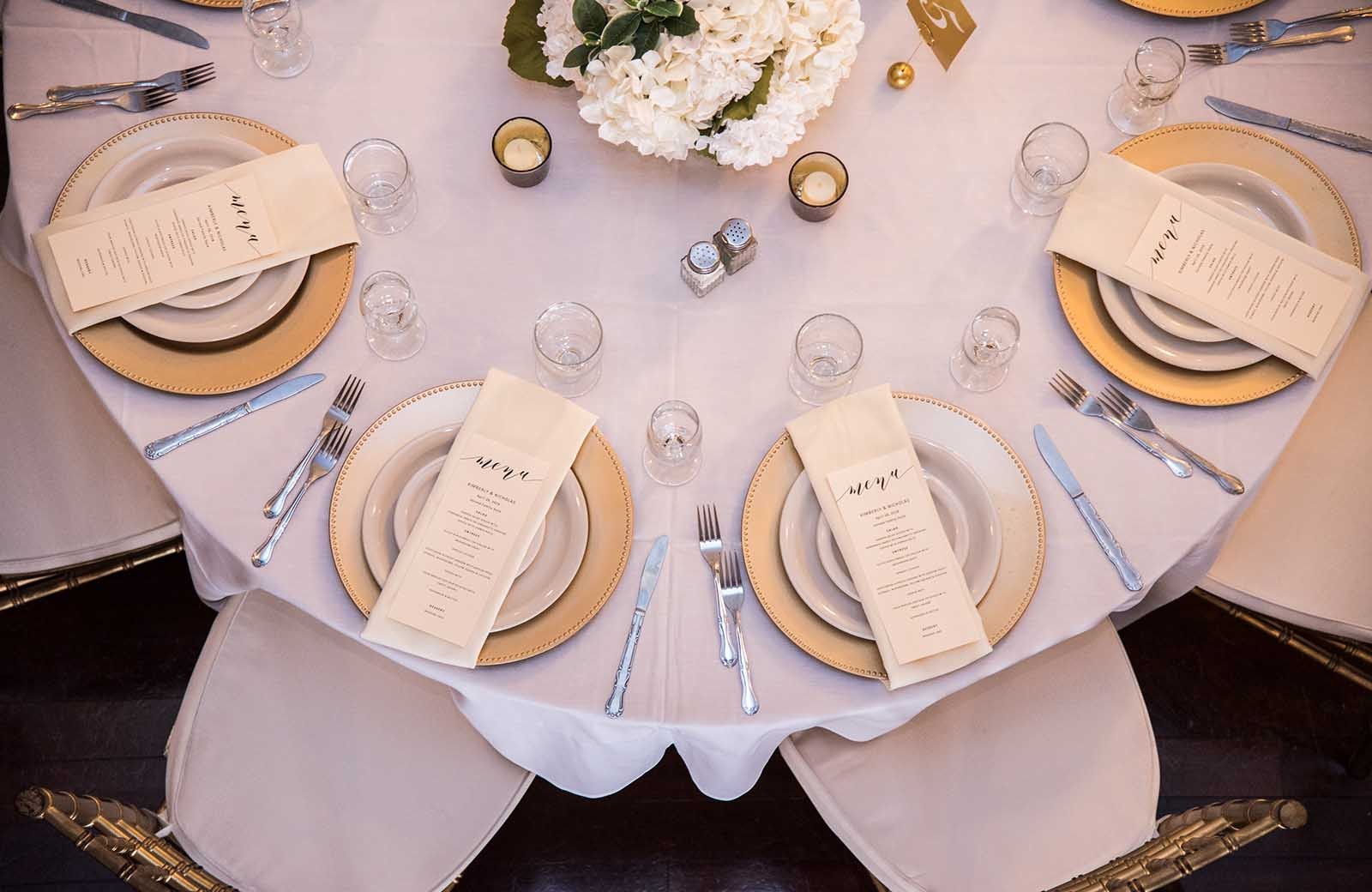 Place Settings: Elegant table settings in the Grande Ballroom at Lafayette Grande, perfect for creating a sophisticated dining experience.