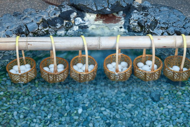 A narrow alley near Netsunoyu features small craft shops offering products inspired by spring water, including milk glass.