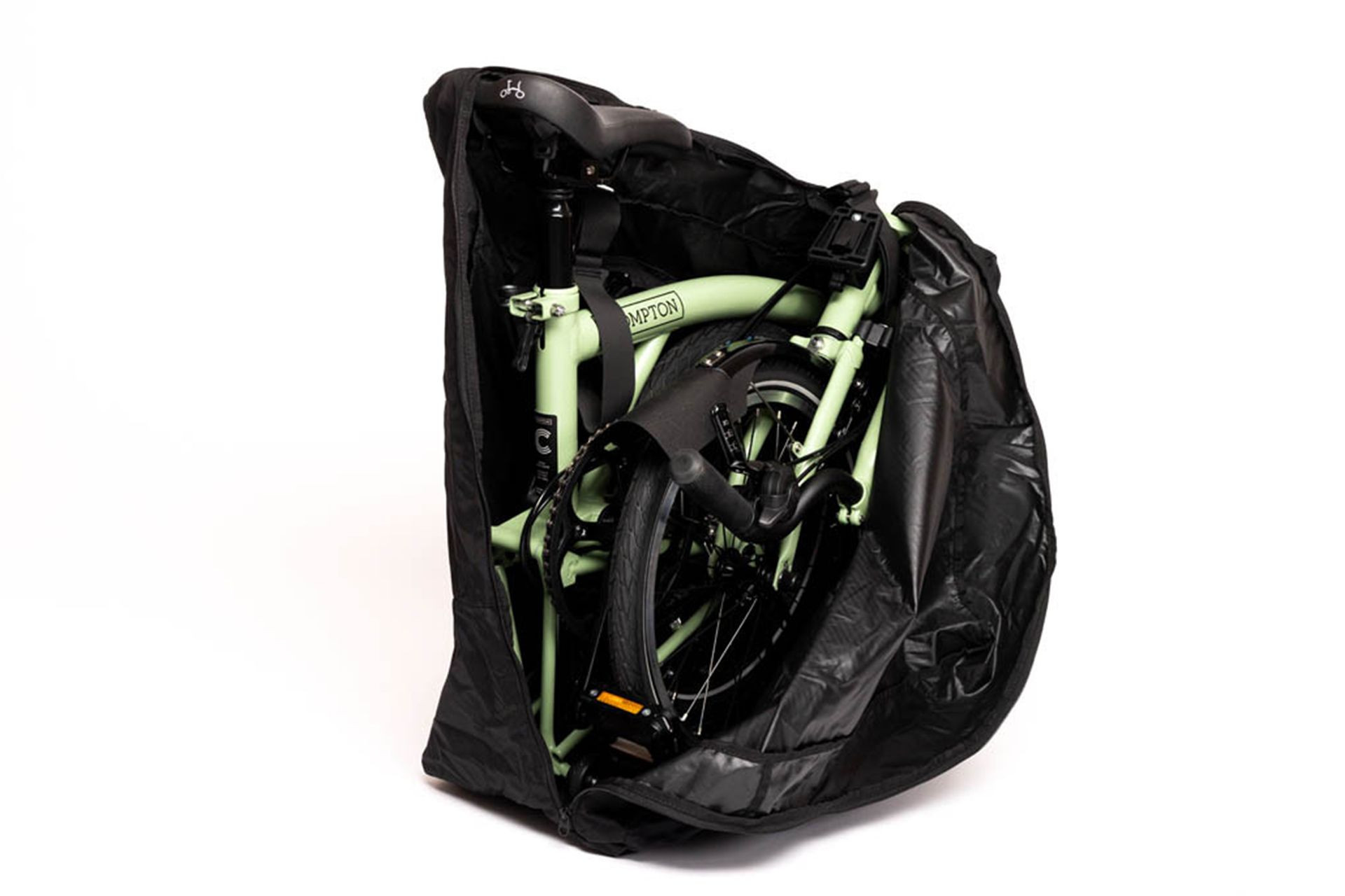 A green Brompton bike folded in a brompton bikes transport bag.