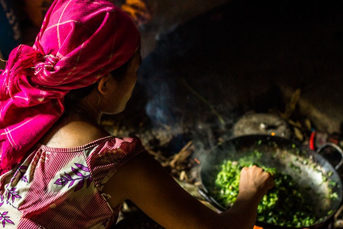 Preparing lunch for a family in Ha Giang, showcasing the communal aspect of meals and the simplicity of rural life.