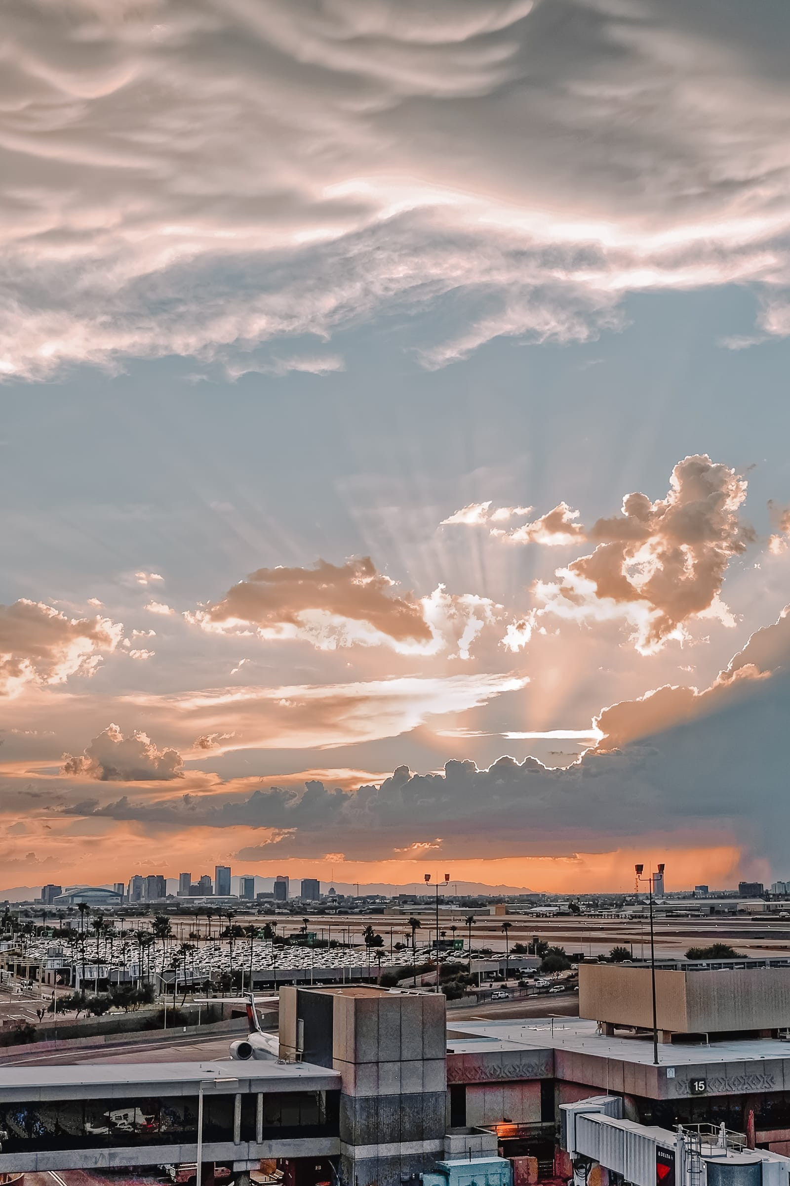 A view of the Phoenix skyline, with a sunset casting a warm glow over the city