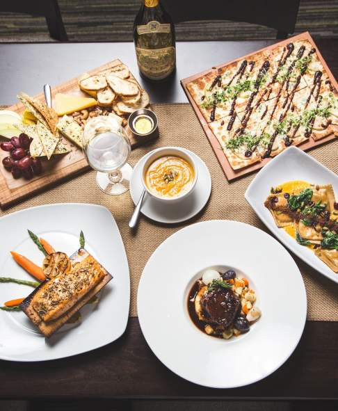 A table presents a colorful array of farm-to-table dishes and fresh vegetables at Harvest Seasonal Grill and Wine Bar in Scranton PA