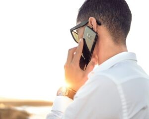 A person on their phone, possibly contacting American Airlines