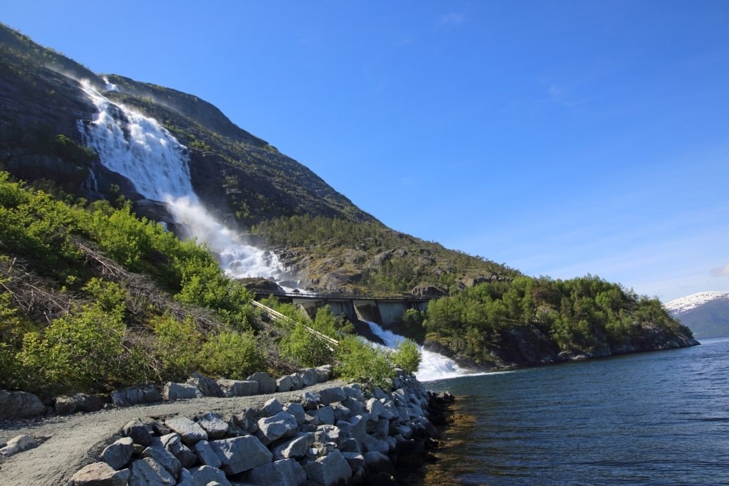 Roadside view of Langfoss Waterfall cascading down the mountain, Haugesund Norway
