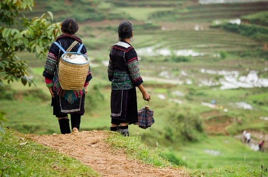 A Hmong woman proudly displays her textile creations