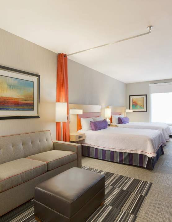 Hotel room with two queen beds and workspace in Fort Smith.