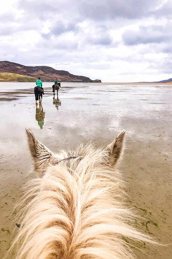 Enjoy horse riding on Dunfanaghy Beach in Donegal, a short trip from Derry, for an unforgettable experience.