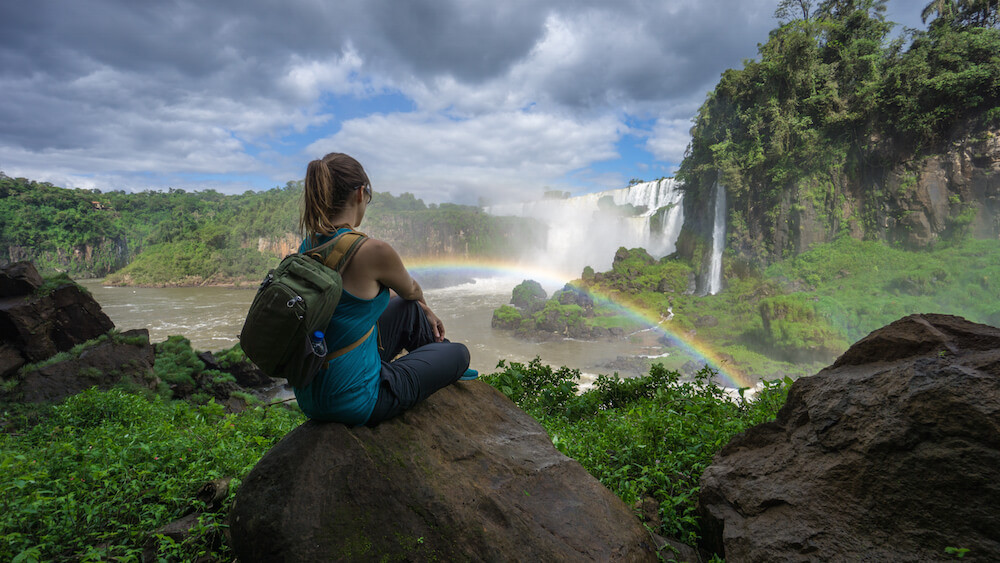 Gazing out over Iguazu Falls with a rainbow in Argentina