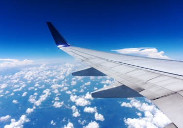 Image of an airplane wing in the sky