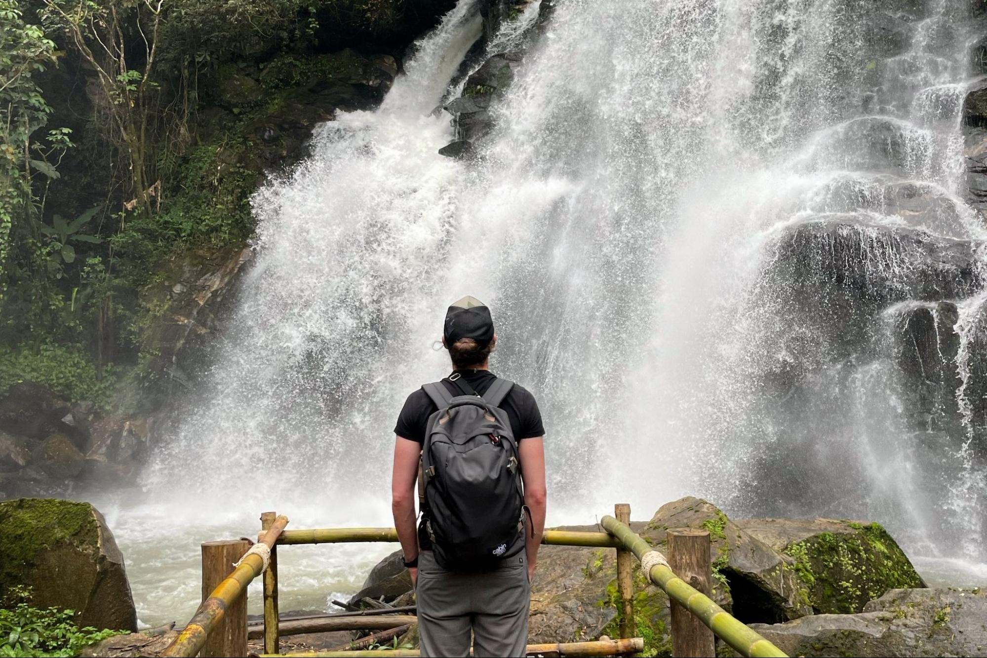 Thailand Essentials - A travel backpack, a passport, and other useful items