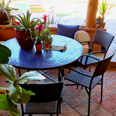 Outdoor dining area with a zellij tile table, perfect for enjoying meals in the intense summer heat, showcasing the India World Traveler Collection's durable decor