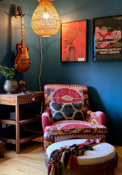 Husband's office featuring an ikat chair and rattan hanging lamp, adding life to Zoom meetings, showcasing the India World Traveler Collection's global inspiration