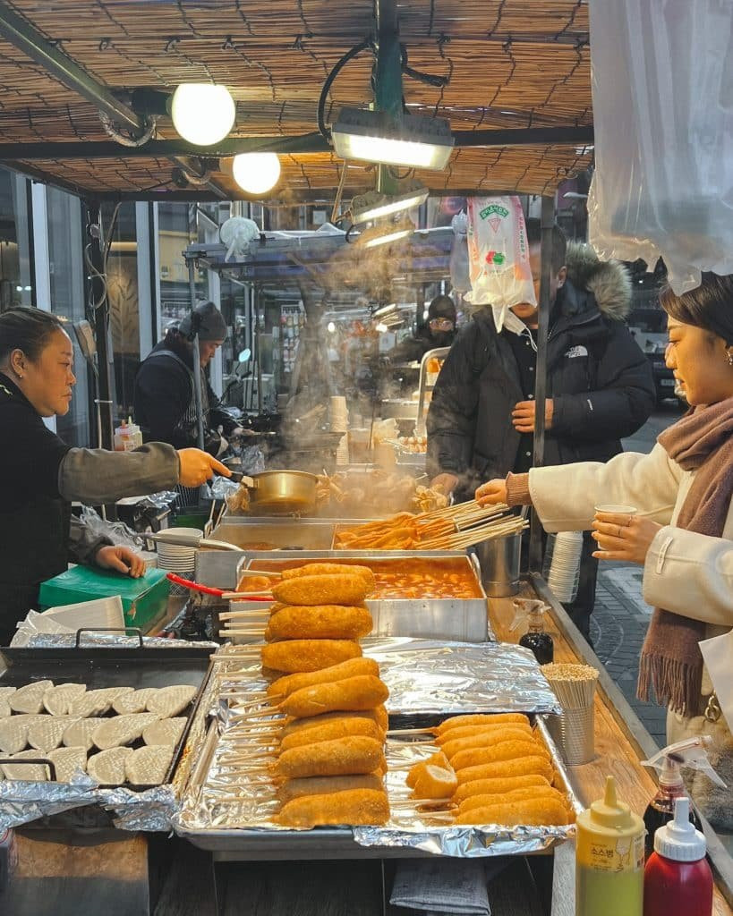 Night view of Myeongdong shopping street with bright lights and bustling crowds