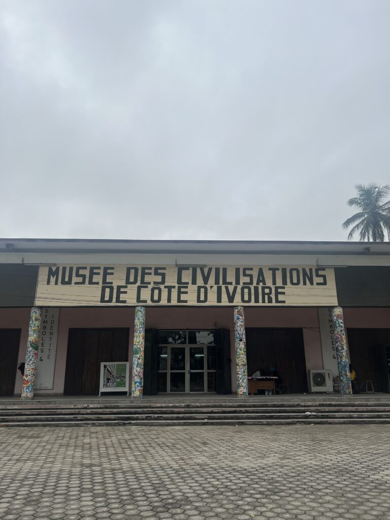 Display of traditional Ivorian masks and artifacts in Musée des Civilisations
