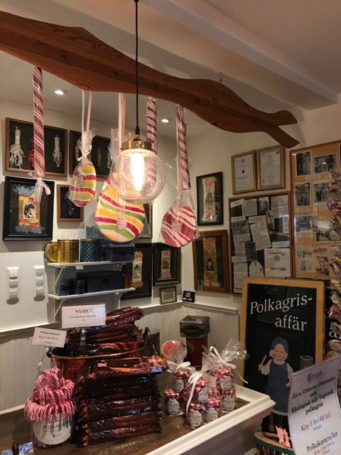 Polkagris store in Gränna featuring a variety of colorful candy canes and sweets displayed for tourists.