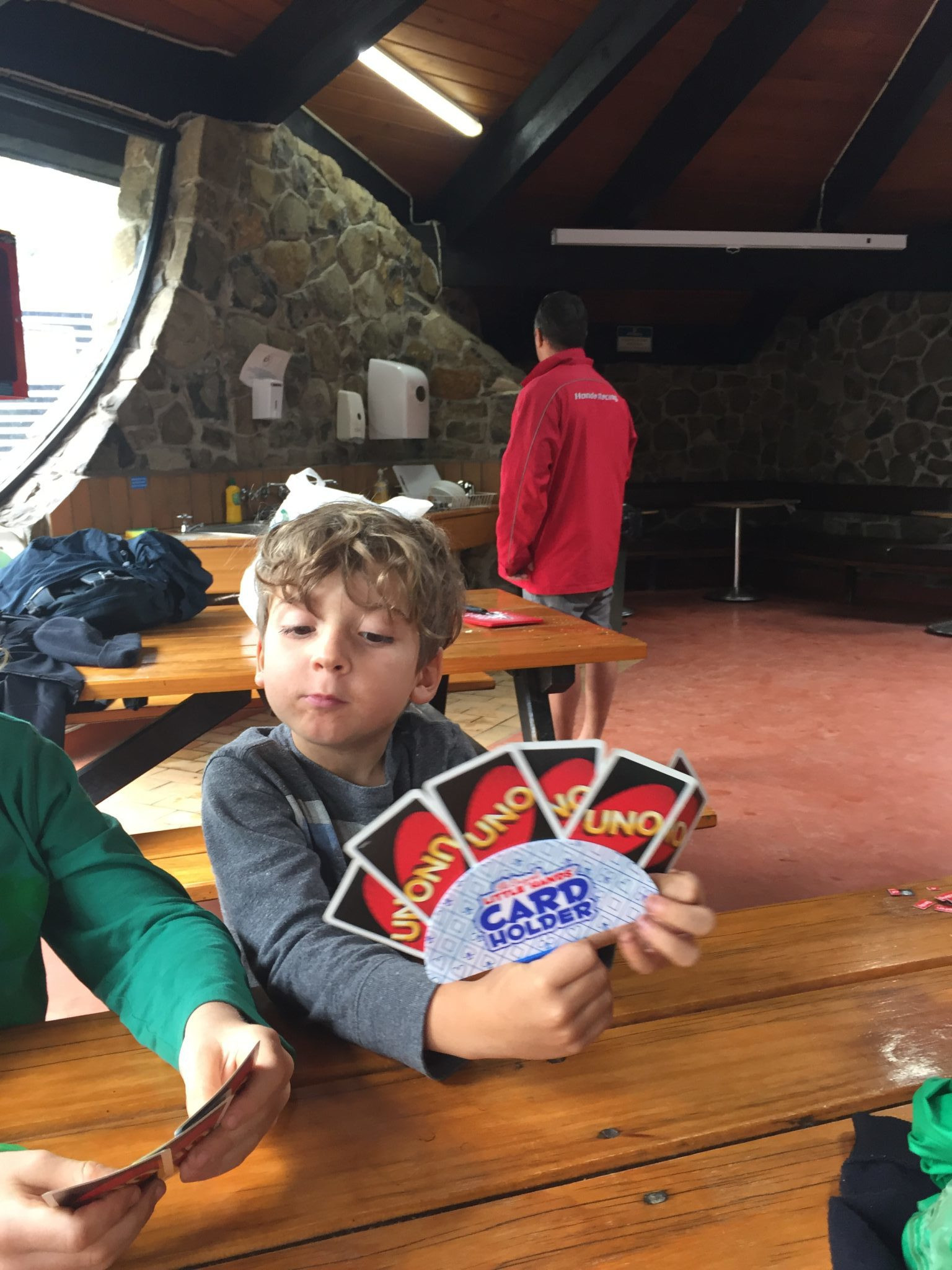 Child using a card holder to play a game