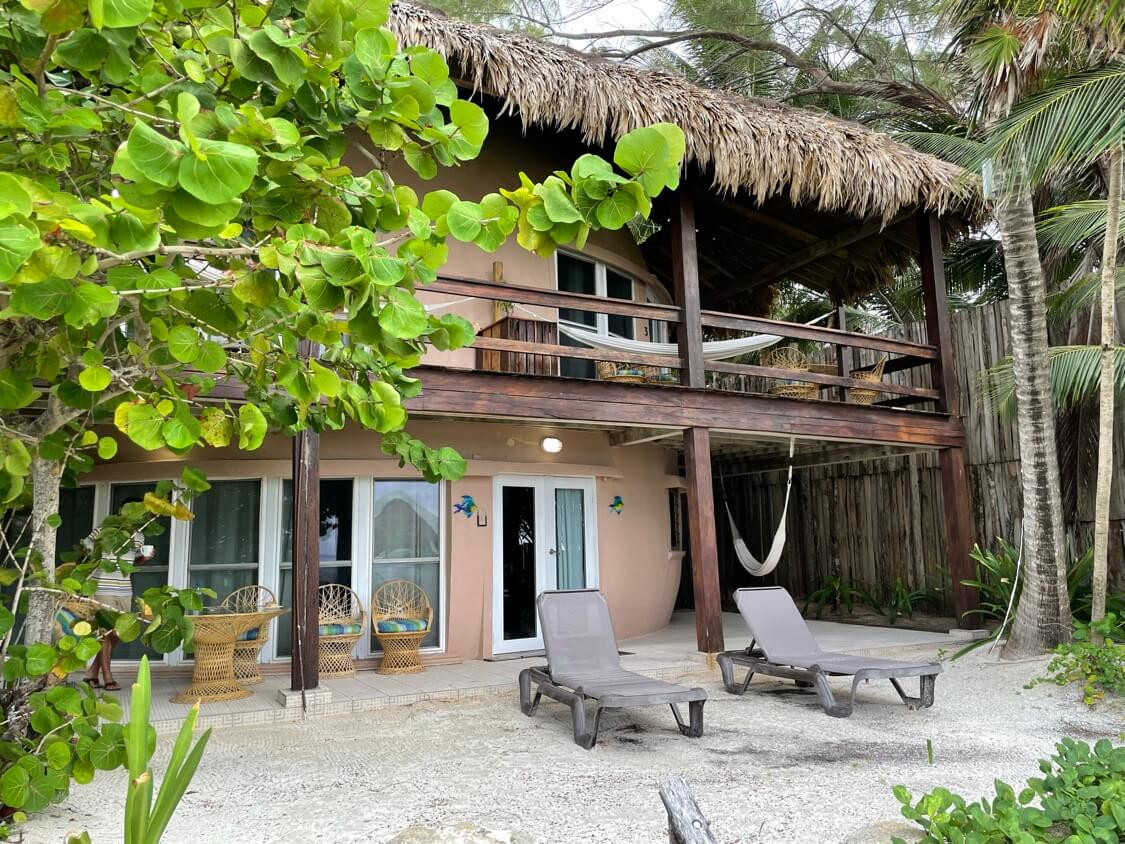 Monolith dome accommodation with patio lounge chairs, hammocks and a thatched roof