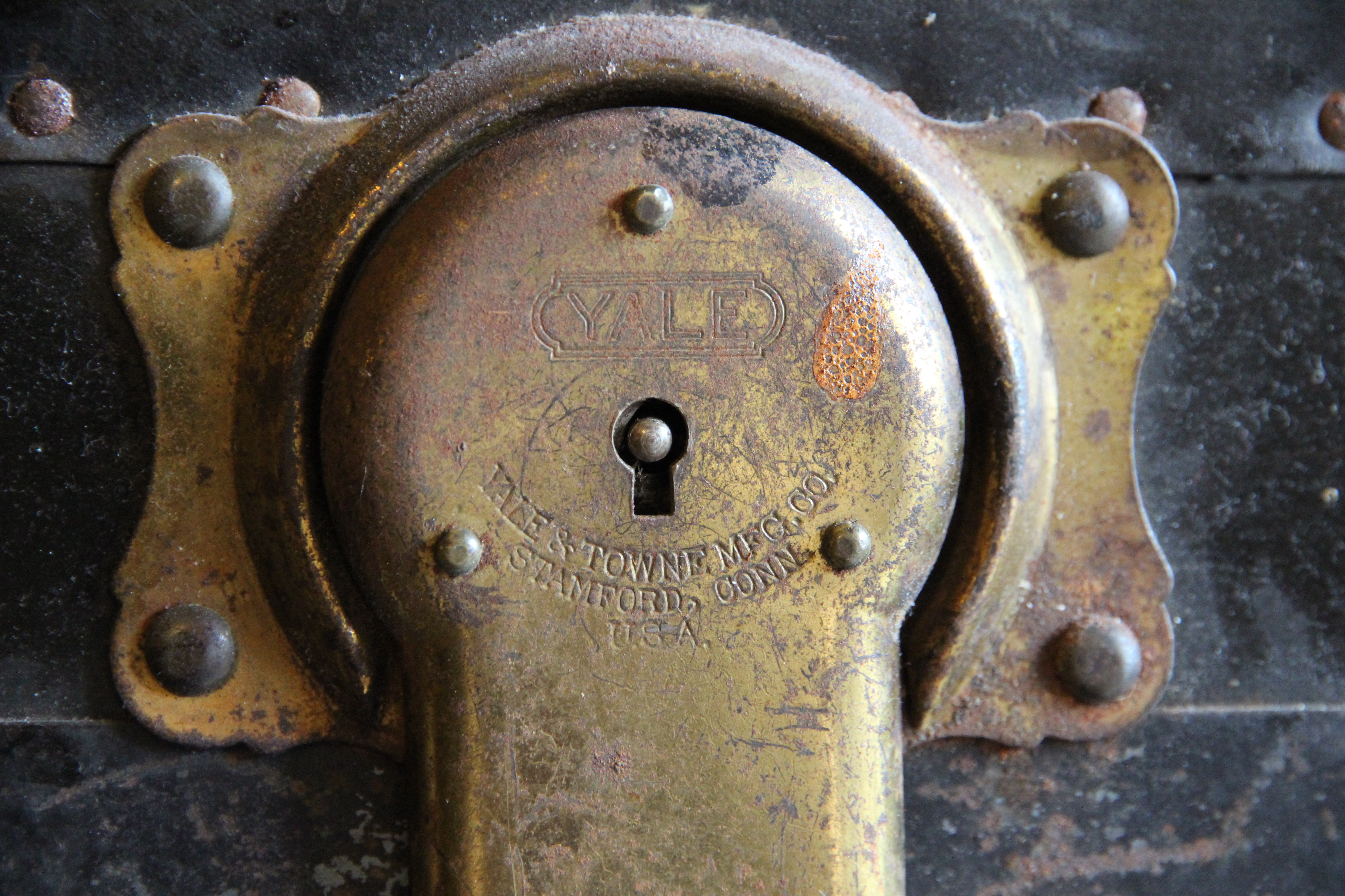 Detail of an antique trunk lock, revealing the Yale &amp; Towne MFG. CO. branding