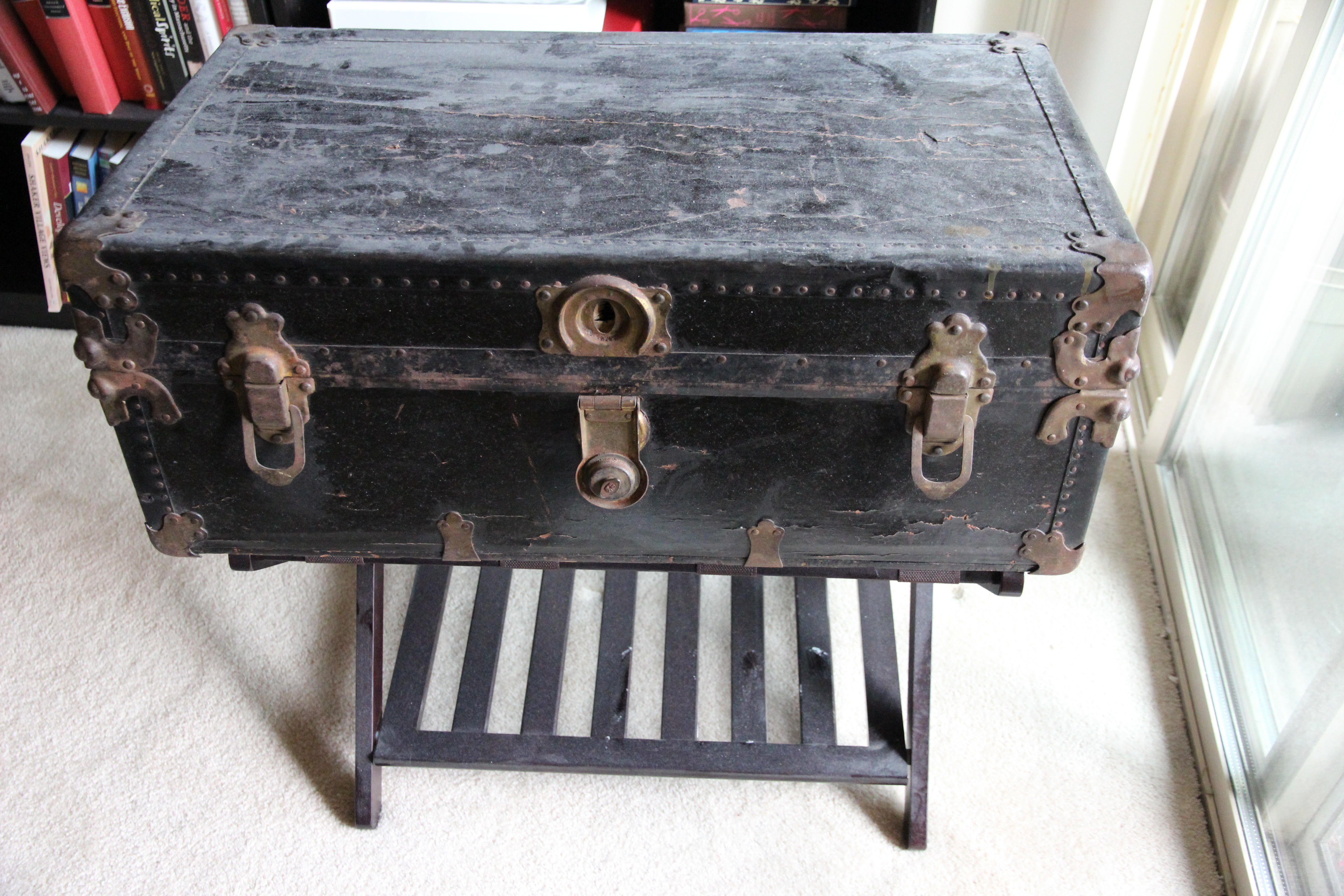 Antique travel trunk displayed in a living room, showcasing its decorative appeal
