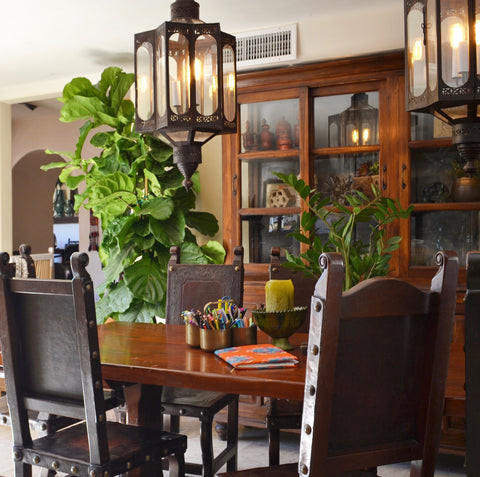 Dining area with classic Spanish Revival style and iron lanterns from India, creating serious drama and showcasing the India World Traveler Collection's eclectic mix
