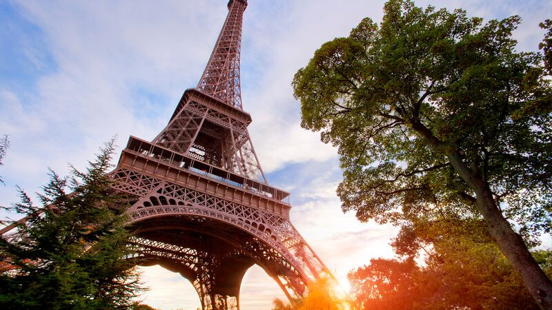 Framework of the Eiffel Tower in Paris at sunset, capturing its iconic silhouette and the romantic ambiance of the city