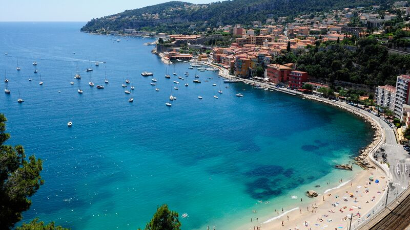 The turquoise waters of Nice with boats floating at sea, highlighting the coastal beauty of the French Riviera