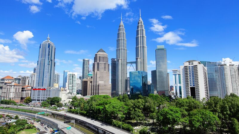 The iconic Petronas Twin Towers in Kuala Lumpur, Malaysia, against a vibrant cityscape