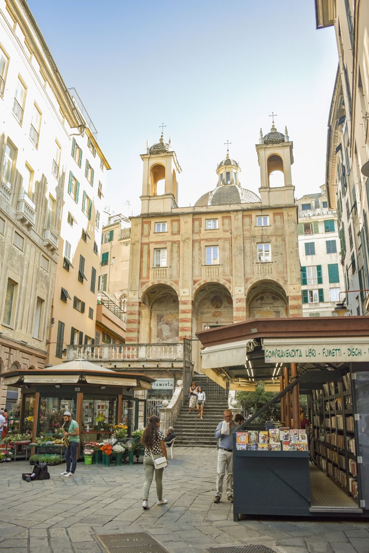 Food market in front of old church in Genoa Old Town.