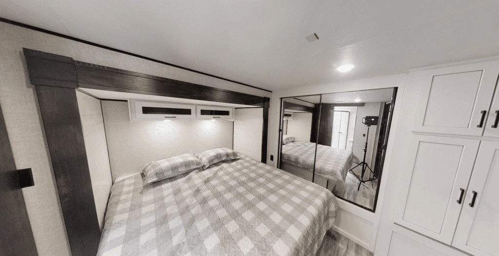 Bedroom in a Jayco Jay Flight 340RLK travel trailer, showcasing the spacious king-size bed