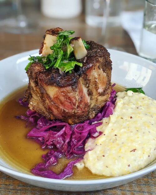 Pork osso buco at J.C. Holdway, Knoxville, displayed on a plate with red cabbage