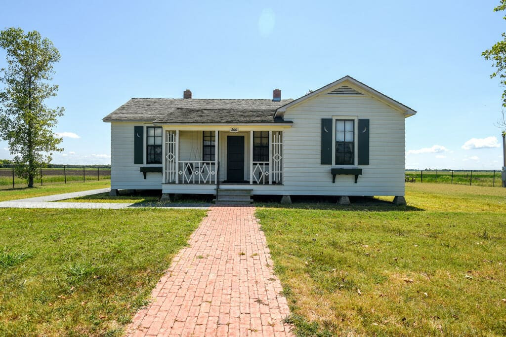 The boyhood home of Johnny Cash. A small white home located on farm land in the town of Dyess, Arkansas. Dyess is located in the upper delta region of Arkansas