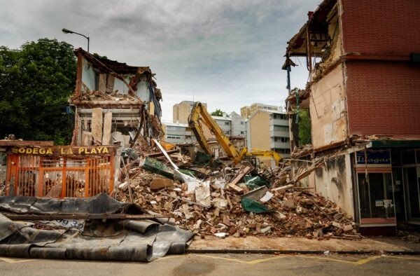 A town in rubble after being affected by an earthquake, emphasizing the importance of having travel insurance