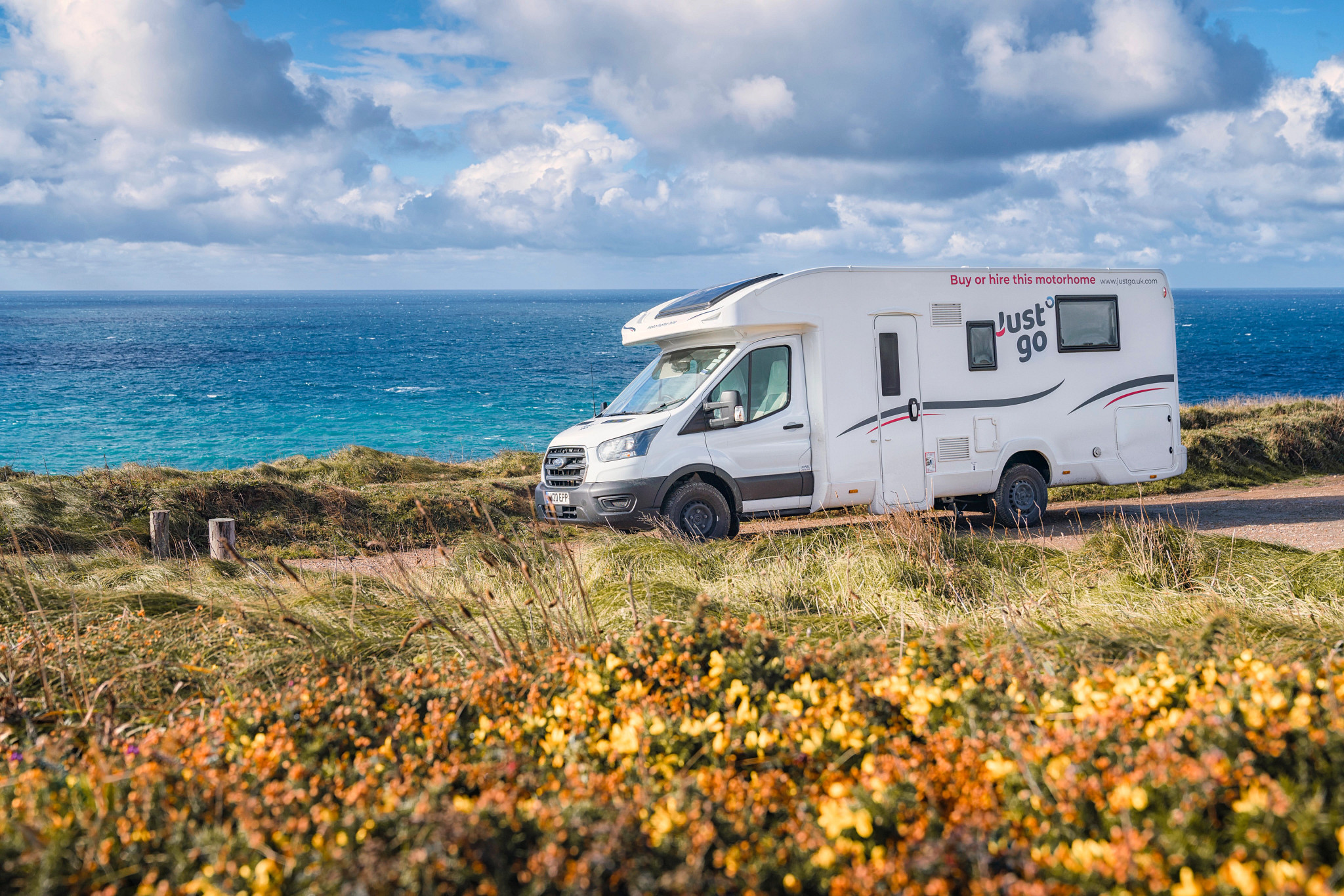 Just Go vehicle parked by the ocean