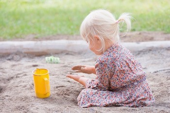 Child playing in dirt, roundworm prevention